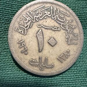 Mint Silver-Toned Coin on Green Textile